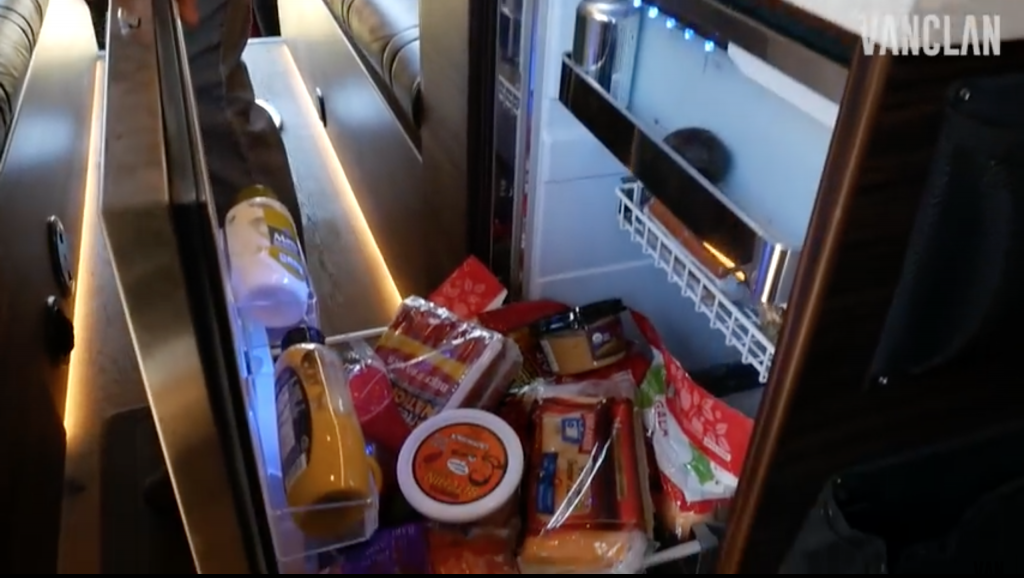 The fridge is big enough to store tonnes of hot dogs! It pulls out from the wall and has a silver trim.