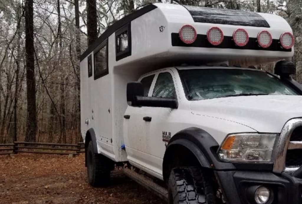 Truck parked in woodland.