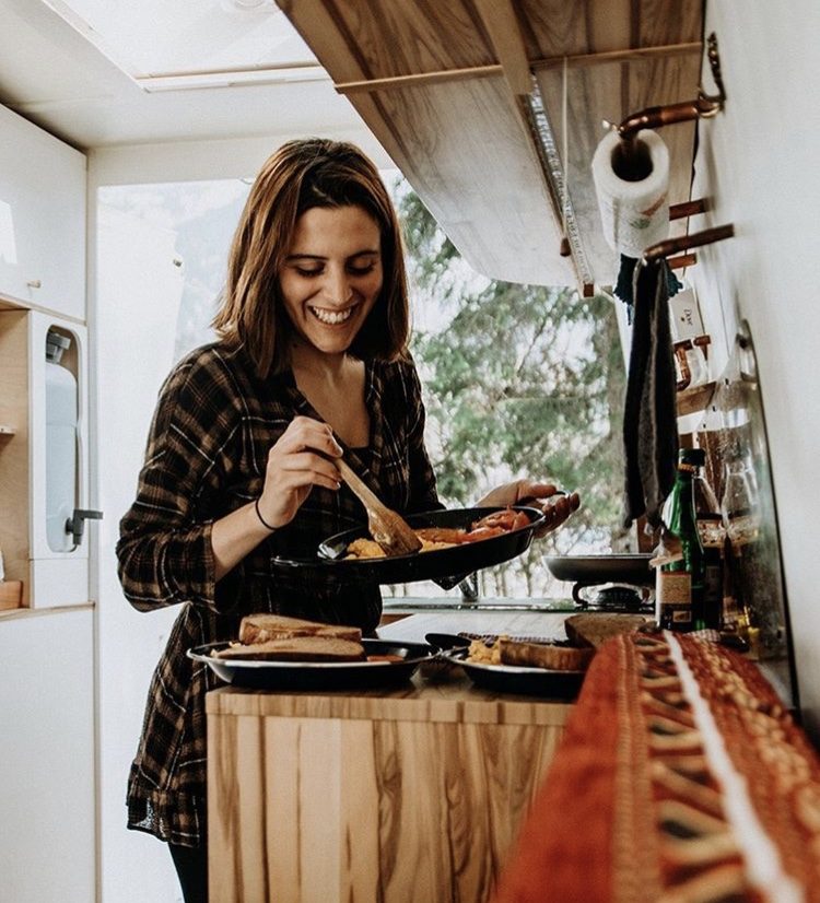 How to live off grid- woman cooking in a van.
