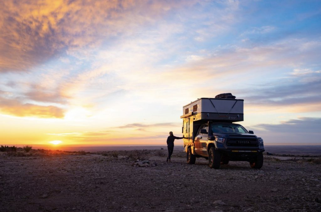 Living in a four wheel camper- camper in sunset.