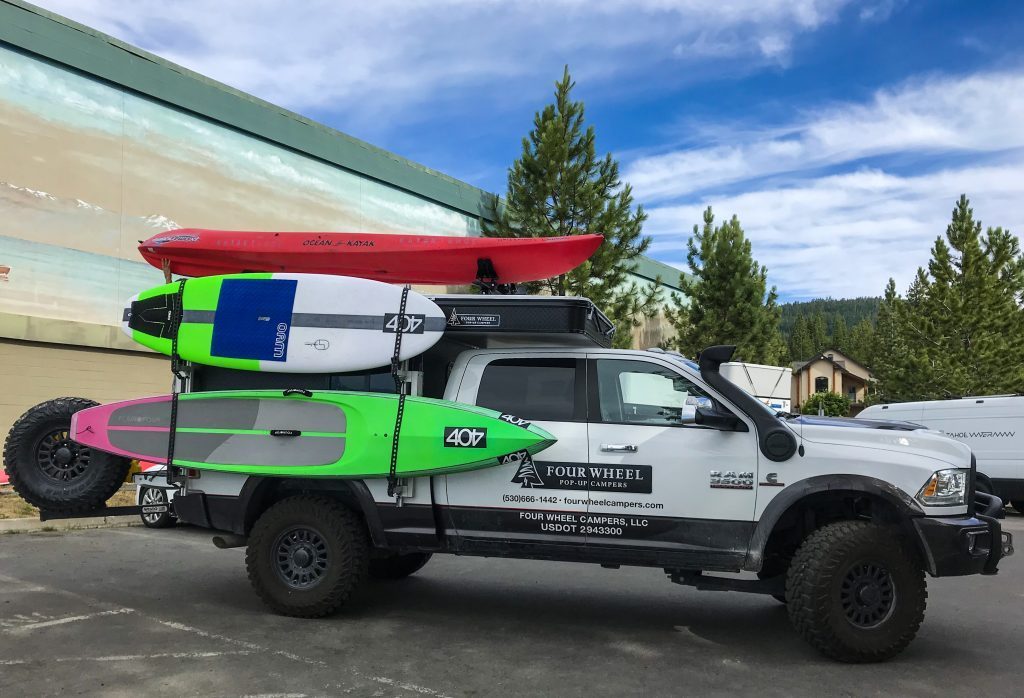 The new camper kitted out with a surfboard, paddle board and a kayak on the roof
