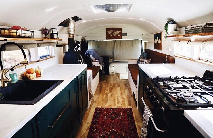 Dark interior with dark turquoise cupboards and red traditional rug.