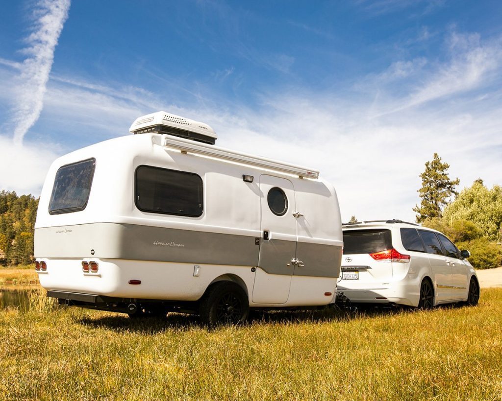 Happier Camper Traveller - camper being pulled by a white SUV