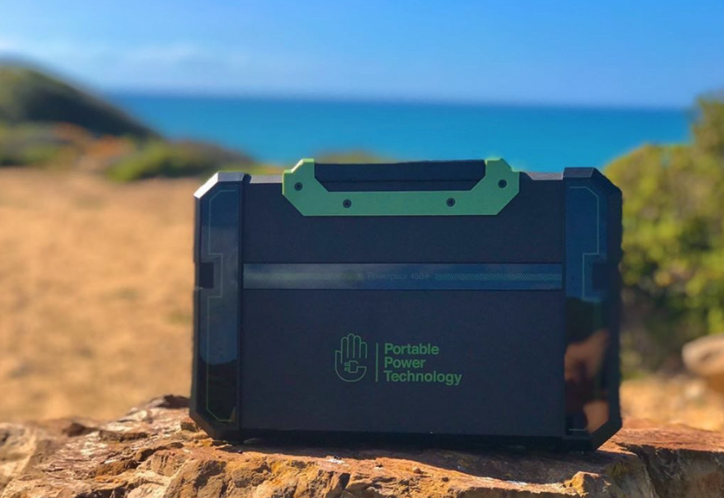 best trailer accessories - a portable power pack on the beach in Sardinia