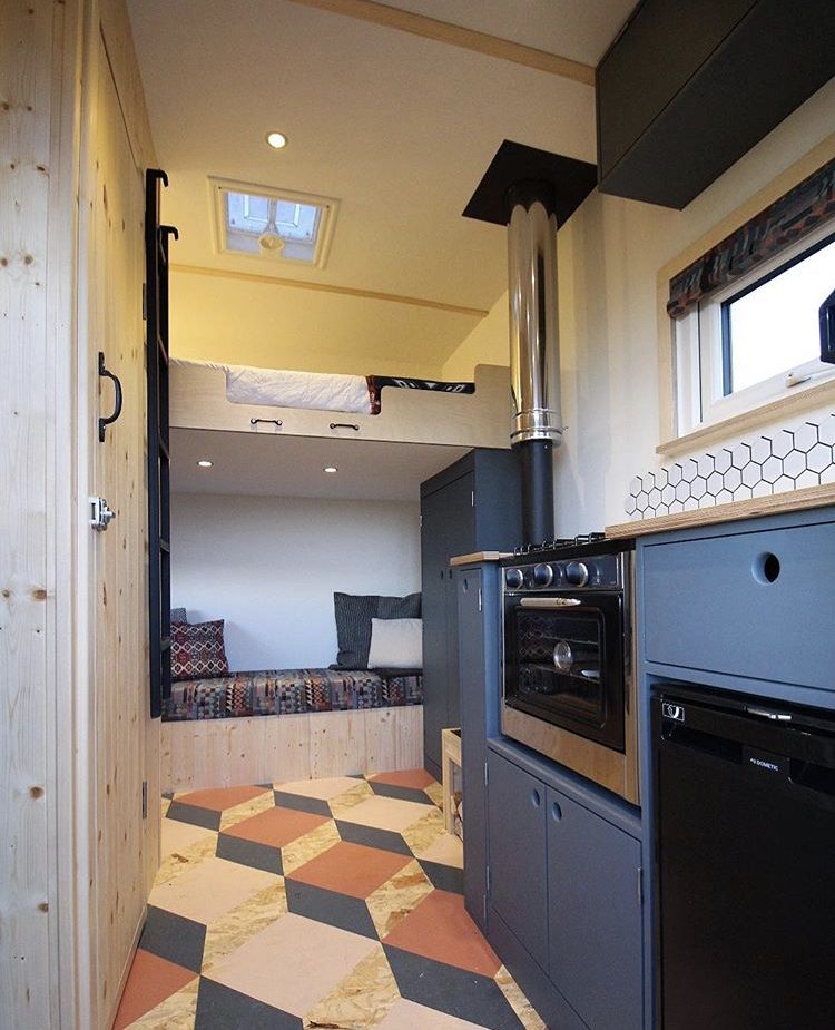 Custom van ideas - van interior with loft bed and blue kitchen.