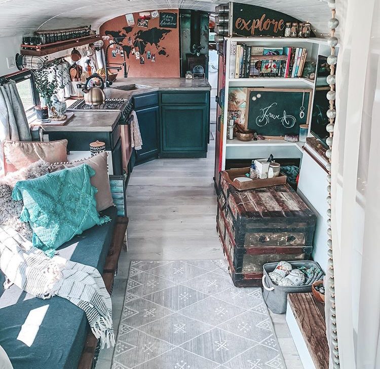 Bus interior, blue kitchen and sofa.