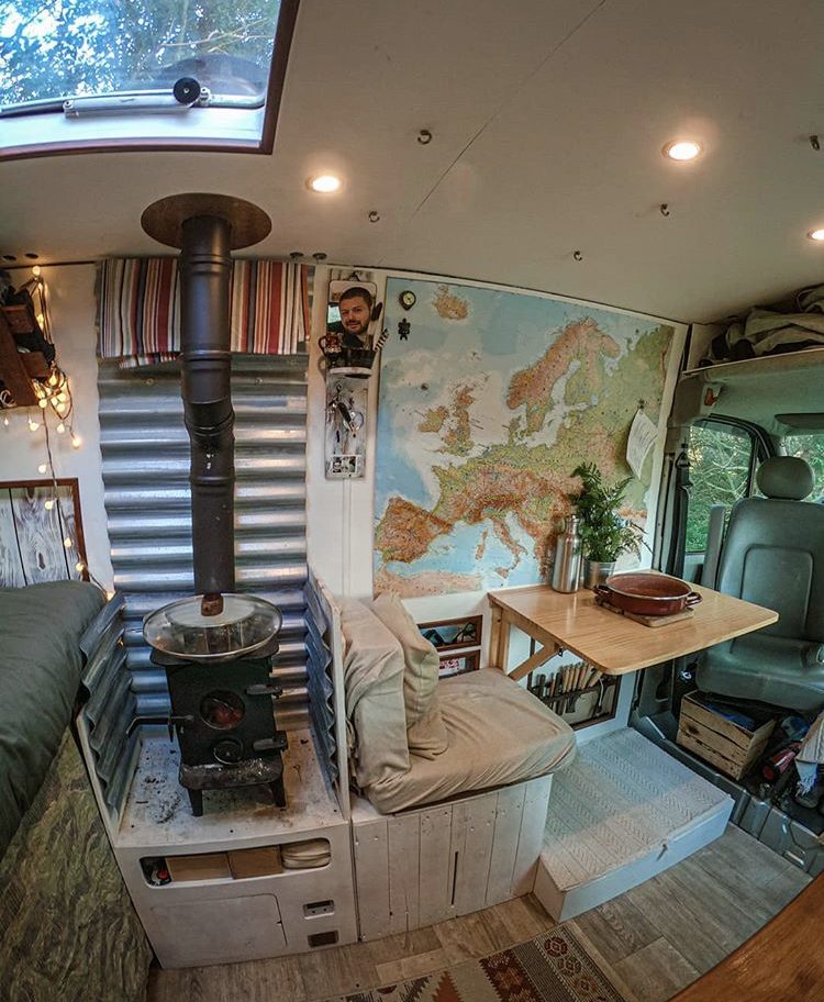 Interior of van with woode burner no table.