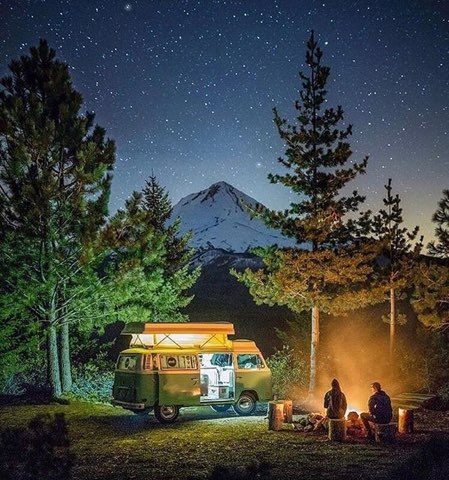 Free camping : VW camp set up in front of snowy mountains