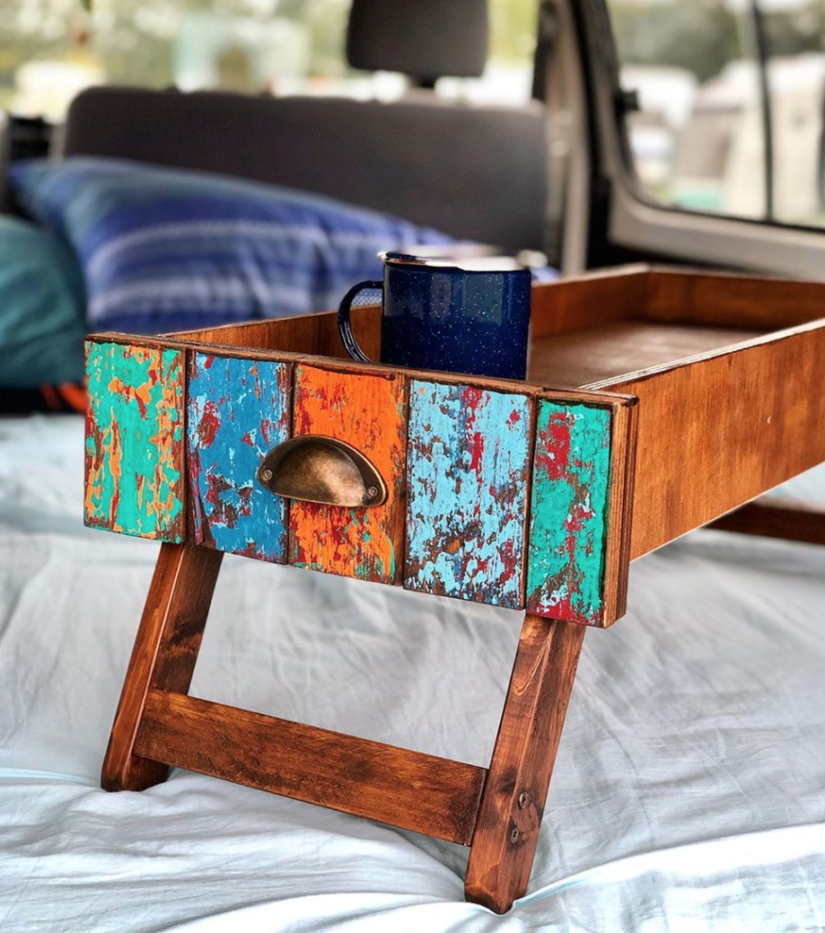 Fold out table storage in a van