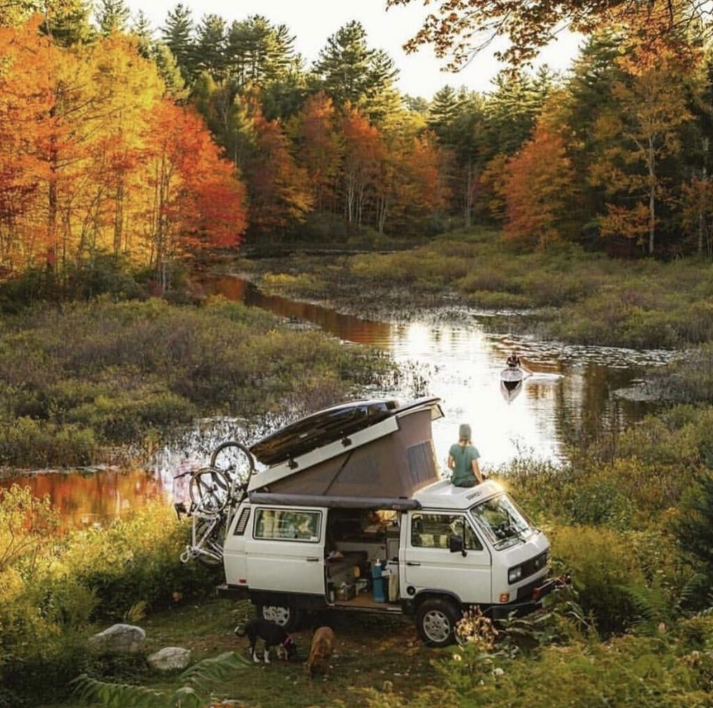 VW pop up in front of river in autumnal scene
