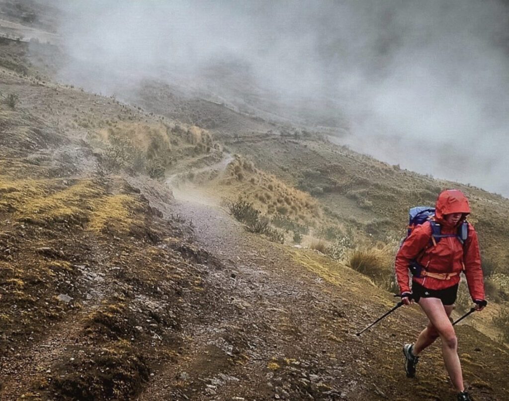 Van dwelling - woman hiking in the rain