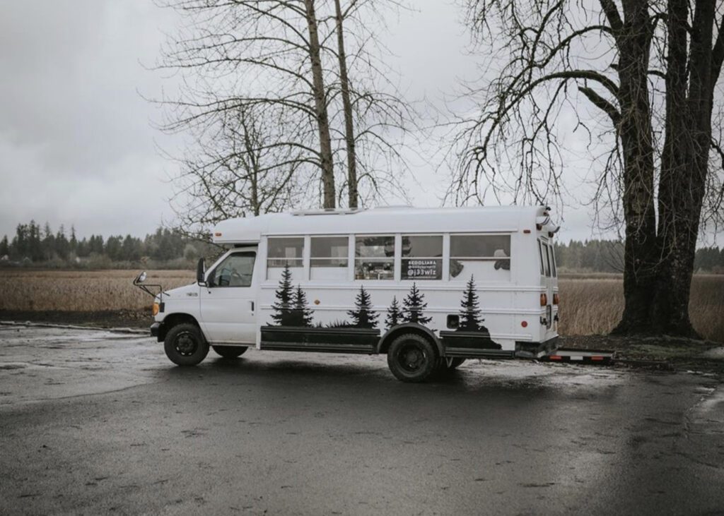 White school bus exterior with trees painted on it