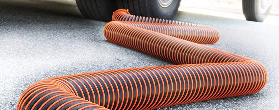 RV sewer hose snaking across the ground