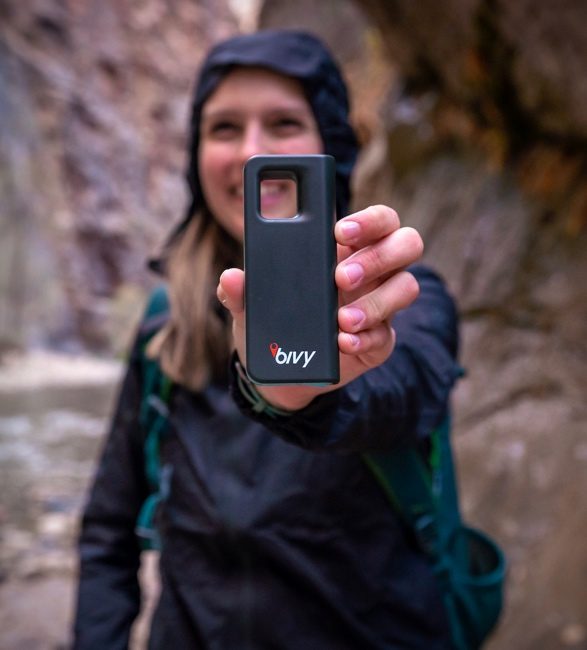 Female traveller holding the portable device