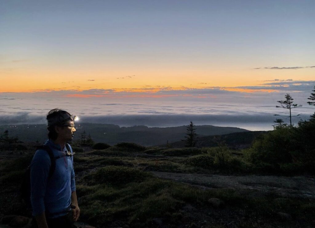 Person walking with headtorch on