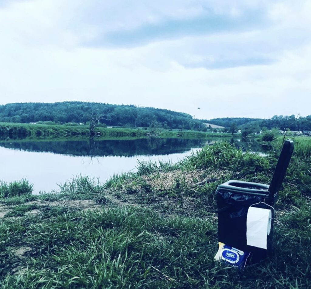 What to bring on a hike - outdoor toilet in front of lake