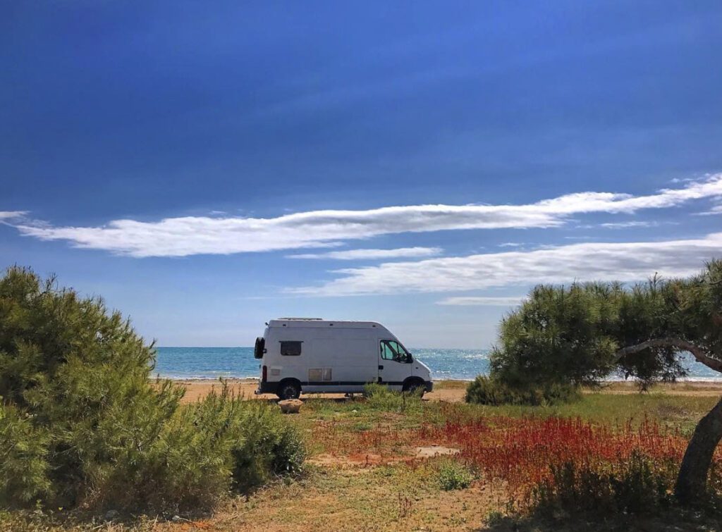 Living n a camper - can on the beach with ocean in background