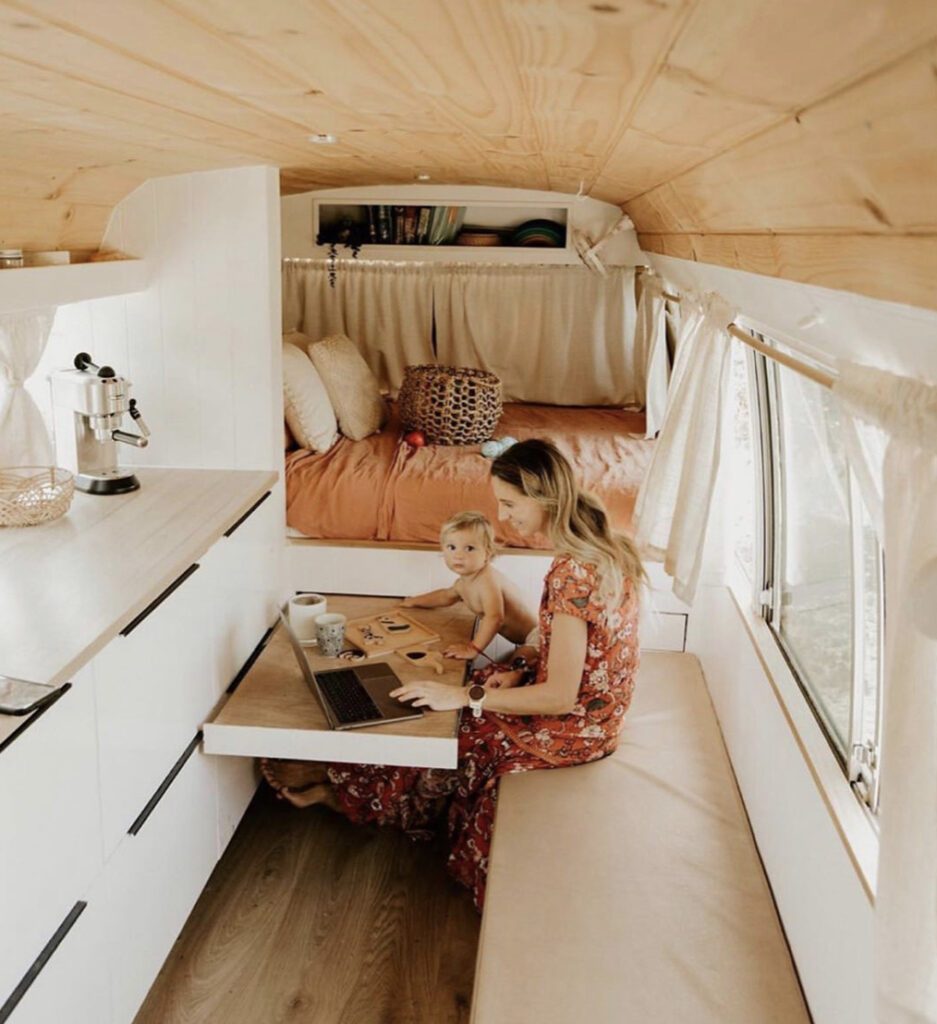 Small RV - woman and baby sat at pull out table