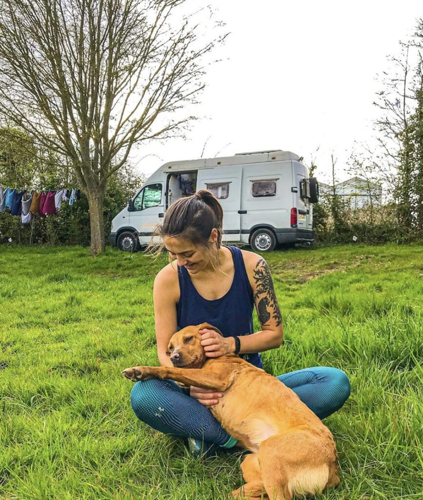 Living in a camper - sat infront of van with dog