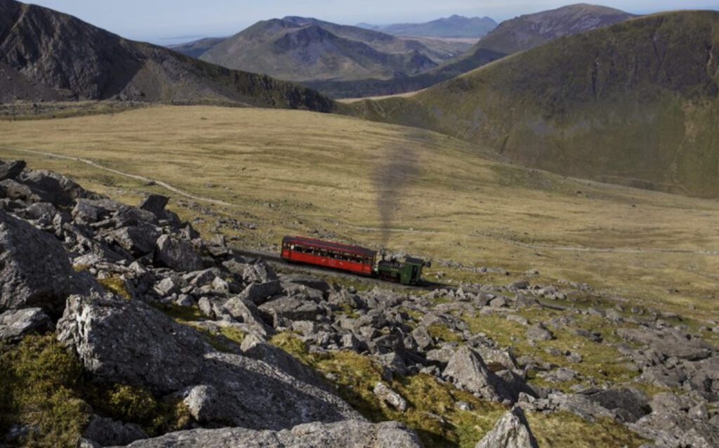 Places to visit in UK - train going up Mount Snowdon