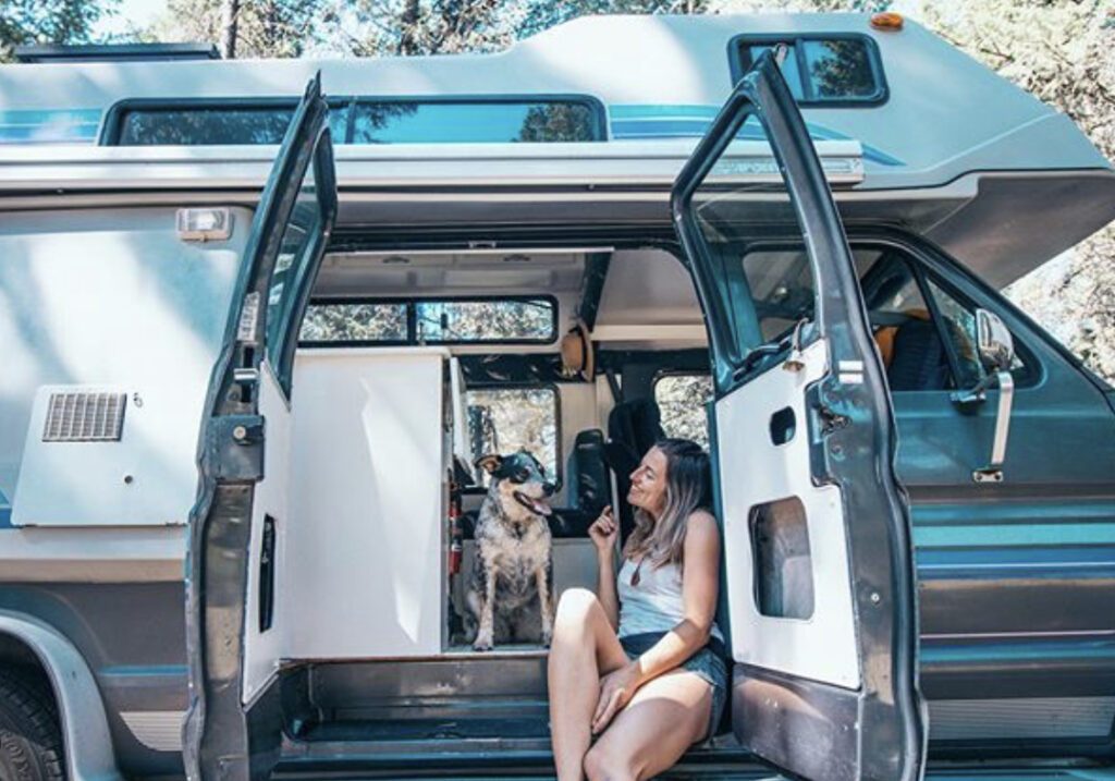 Camping with dogs - woman and her dog in camper