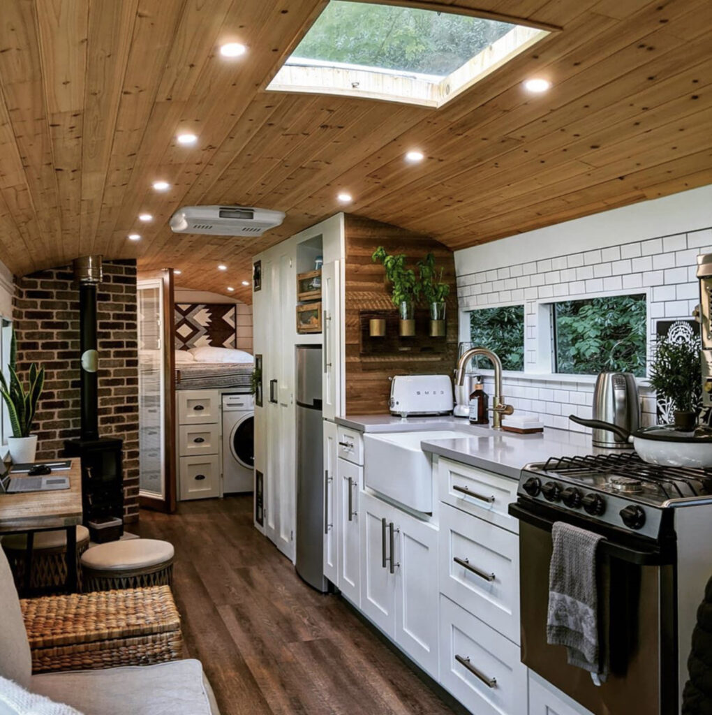 Large white kitchen in skoolie conversion