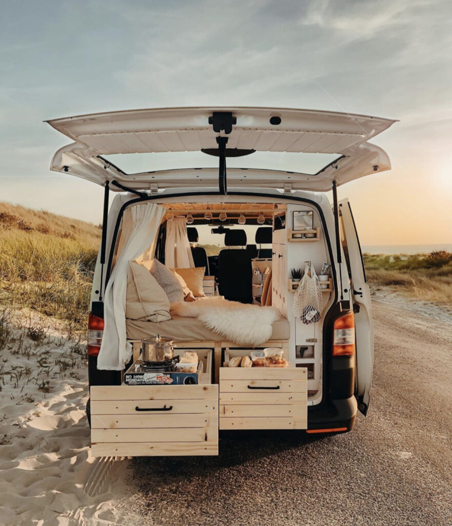 Smaller van parking by the beach, slide out kitchen at back