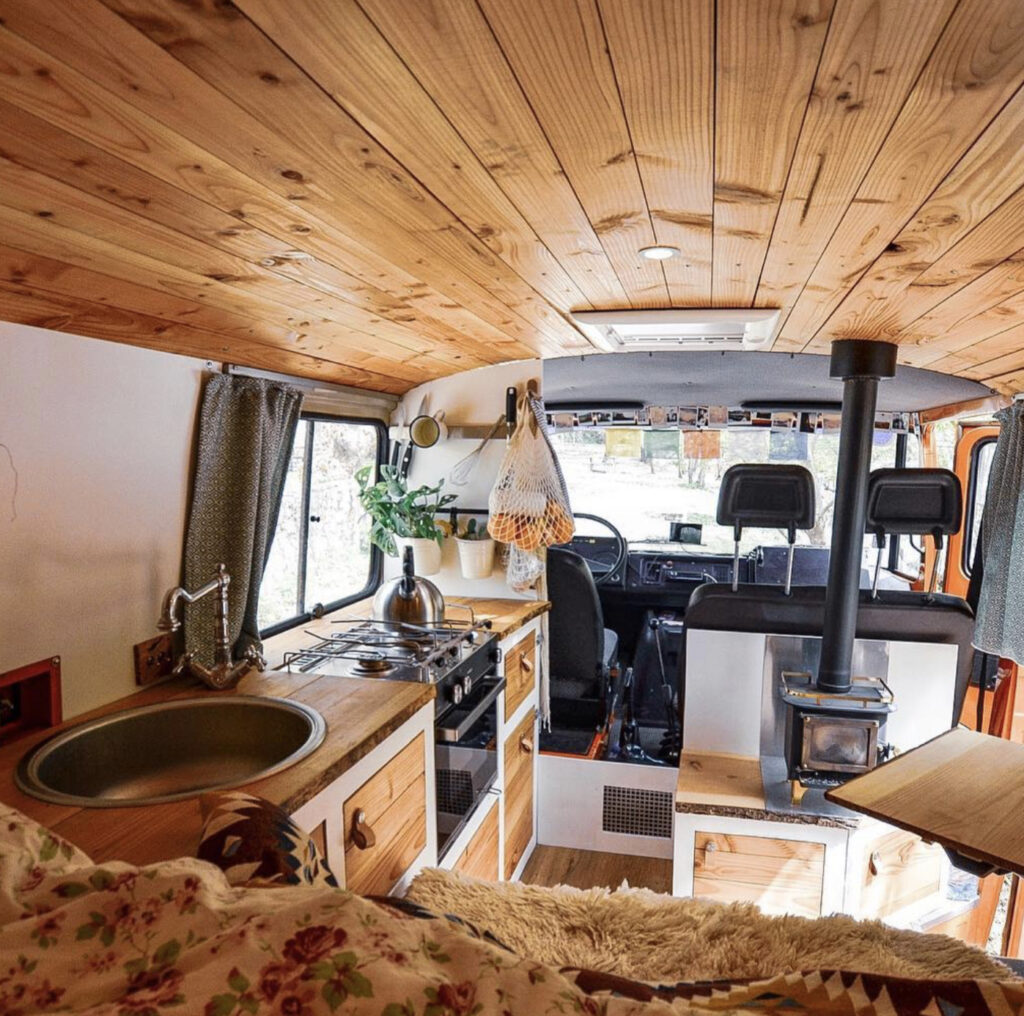 Larger van with fixed bed, seat, kitchen and wood burner
