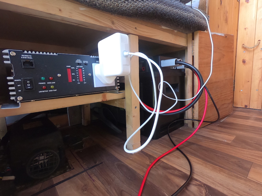 Campervan electrics showing our power hub and inverter under our seat.
