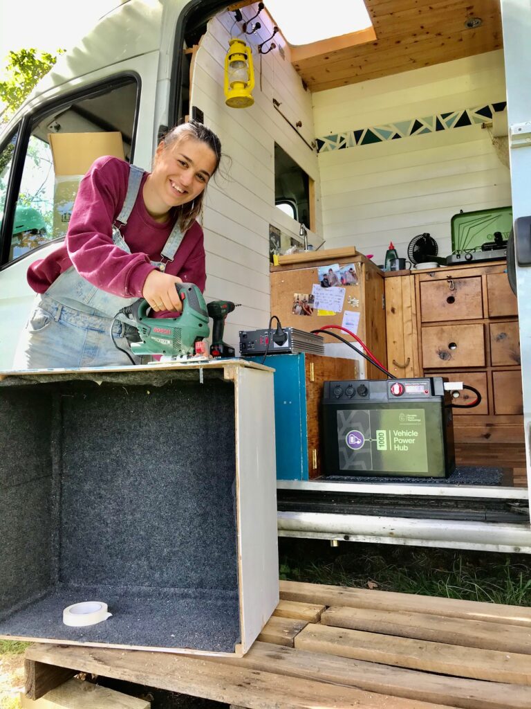Campervan electrics - Rose using the Vehicle Power Hub outside our van