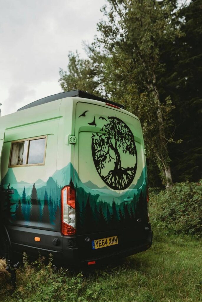Handcrafted Rustic Campervan with a tree logo on the back, custom